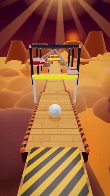 Video cover: Skyroll, a white ball rolling on a narrow wooden bridge above orange clouds